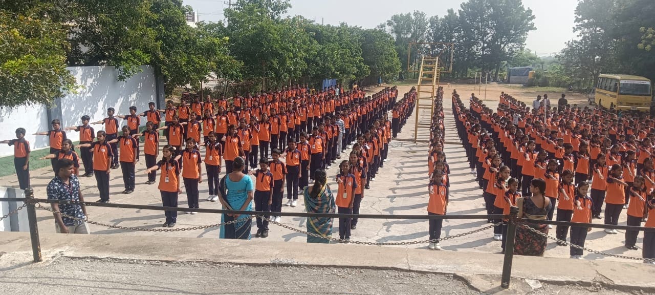 Students in uniform standing in long rows during a school assembly