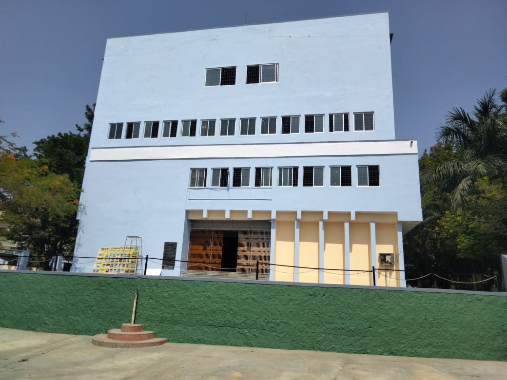 The three-storey blue school building of SV English Medium High School in Pavagada