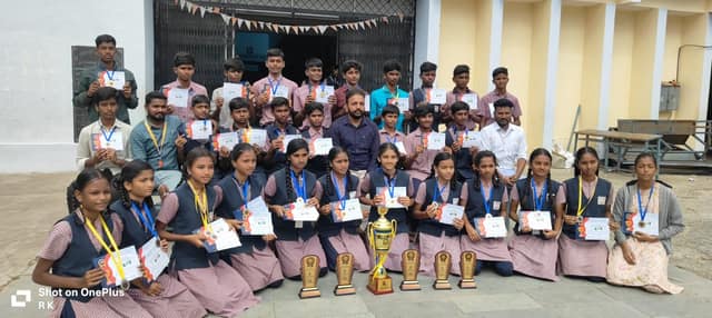 A group of students holding certificates and a trophy