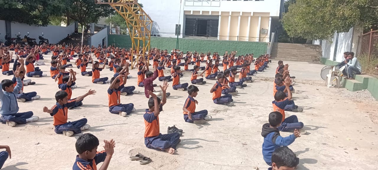 Students in a group exercise session on the school ground